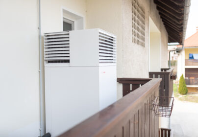 HEAT PUMP SPOTTED ON THE BALCONY OF A MULTI-APARTMENT HOUSE IN AN IDYLLIC TOWN